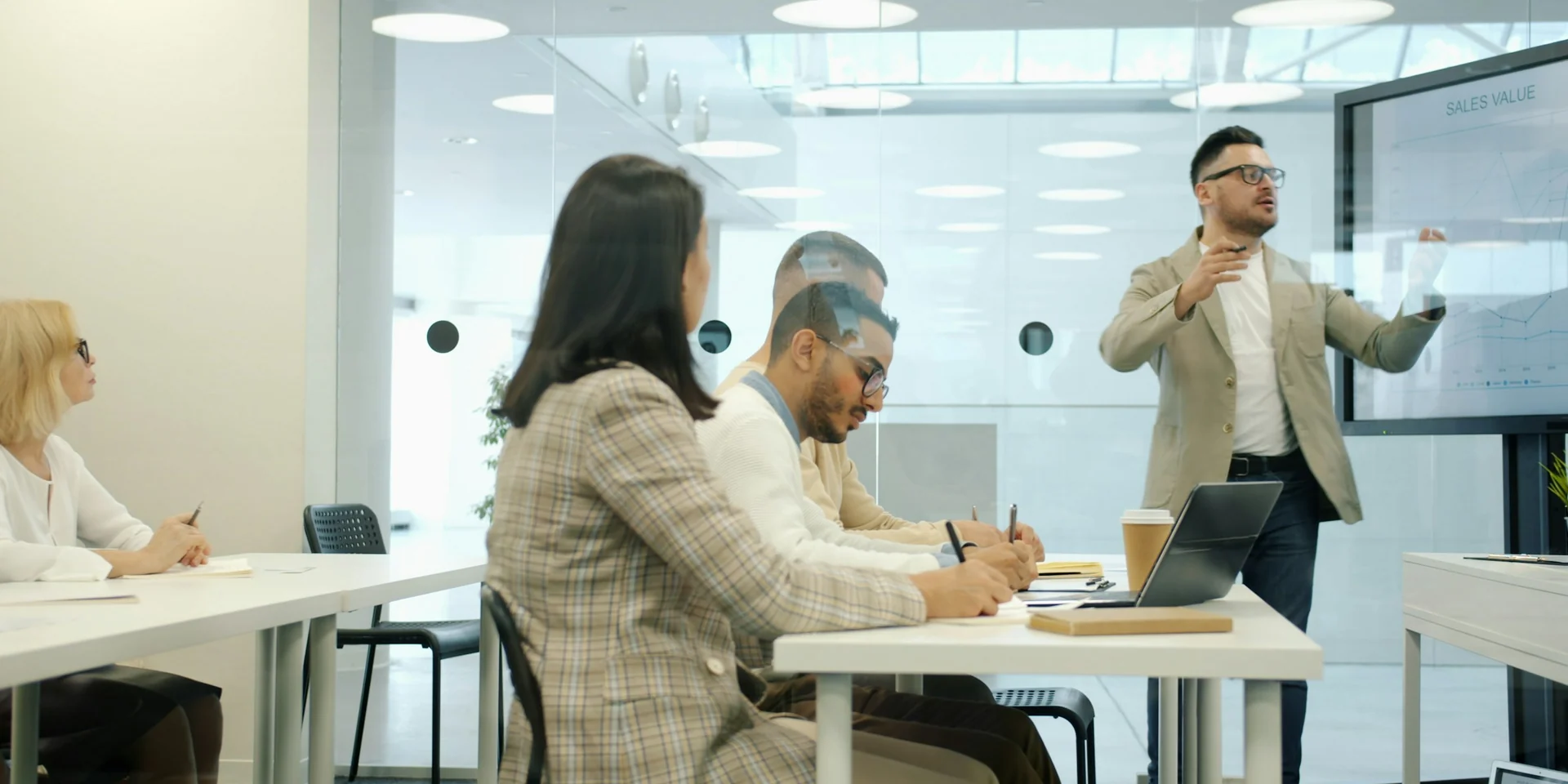 Professionals collaborating around a table in a modern conference room.
